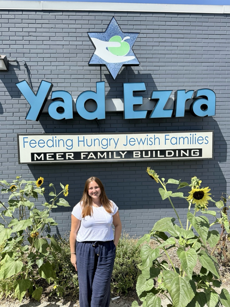 Audra, Yad Ezra intern in front of their building
